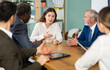 © JackF - Business partners or employees of corporation sitting at table, talking and discussing. Staff or co-founder during discussion of companys development strategy, collegial decision, coaching course. .