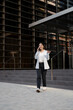 © Mauro Grigollo/Stocksy - A Businesswoman walks out of the office