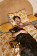 © Malquerida Studio/Stocksy - Man and dog sleeping hugging each other