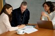 © Studio Sincère/Stocksy - Couple signing a contract in agent's office