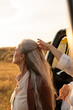 © Alba Vitta Studio/Stocksy - Helping hand at sunset