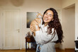 © Aleksei Toropov/Stocksy - woman is holding a small ginger kitten in her arms