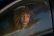 © Studio Sincère/Stocksy - Woman With Curly Hair Gazes Thoughtfully out of a Car Window