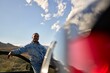 © Studio Sincère/Stocksy - Reflective Moment of a Man by a Car in a Scenic Landscape