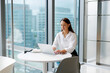 © Artem Podrez/Stocksy - Businesswoman Using Laptop in High-Rise  in Modern Office