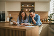 © Miljan Živković - Couple working on household budget, managing financial stress