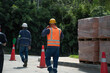 © Laura Herrera/Stocksy - Construction workers managing safety at a busy site in daylight