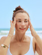 © ohlamourstudio/Stocksy - Woman Enjoying a Skincare Routine on the Beach During Midday