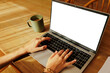© BONNINSTUDIO/Stocksy - Woman working remotely from home with laptop and coffee