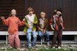 © Irina Ozhigova/Stocksy - Group of children dressed in colorful outfits posing playfully