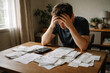 © Moddy - A man is experiencing distress while dealing with his financial papers and a calculator. His face reflects worry and frustration