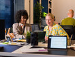 © Milles Team/Stocksy - Two Women Discussing Ideas in a Modern Office Space