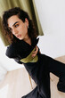 © Tania Cervian/Stocksy - Queer man posing in stylish jumpsuit with corset
