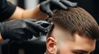 © Rhayron - Barber using electric clipper to give a fade haircut to a client in a modern salon, close-up on hands and hairstyle.
