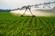 © Volodymyr - Irrigation system. Agricultural cultivation with watering and sprinkler technology. Agricultural irrigation system. Sprinkler equipment in the field. Irrigation and watering system in farmland