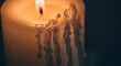 © Aura - Close up of a warm glowing flame on a white candle with thick wax drips in a moody atmosphere