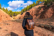 © unai - Woman hiking through las arcillas natural park exploring red clay canyon