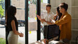 © matinee - UX UI design team collaborating around a desk with mobile app wireframes and interface layouts, discussing user experience, usability, and digital product design.