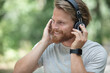 © auremar - young man listens to music outdoors
