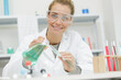 © auremar - young attractive female scientist holding a flask