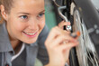 © auremar - female mechanic using screwdriver to work on a bicycle