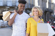 © auremar - young multiethnic couple with bags outdoors