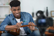 © auremar - handsome young blogger is fixing a guitar