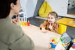 © littlewolf1989 - Speech therapist working with a young girl on articulation and developmental skills, performing logopedic exercises during an educational session