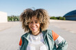 © Westend61 - Confident young woman with curly hair during sunny day