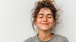 © Anatoll Paveel - A girl smiles broadly, her eyes closed, against a white background. Lifestyle, different emotions, leisure concept