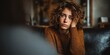 © Anatoll Paveel - A young woman suffering from stress anxiety disorder sits on a couch in a clinic, undergoing a therapy session with a psychologist.