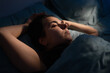 © Andrii Lysenko - Close-up of woman face in night light. Girl drifts off sleep in her bed. Concept of insomnia, sleep disorder, poor rest and sleepless nights