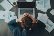 © Arfa_Media - Stressed businessman sitting at a dark office desk, head in hands, surrounded by numerous documents and a laptop, feeling overwhelmed and frustrated by work pressure and deadlines