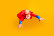 © deagreez - Dynamic senior superhero in red cape flies through bright yellow background inspired by retro fantasy and family entertainment