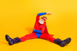 © deagreez - Hero in red and blue costume strikes dynamic split pose on bright yellow background for bold stock photography