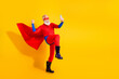 © deagreez - Funny senior superhero in red cape taking a selfie against yellow background