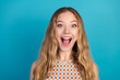 © deagreez - Young chic smiling woman with long blonde curly hair wearing a checkered top against blue background for fashion lifestyle advertising