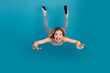 © deagreez - Young woman jumping in air with a big smile on blue background standing out in casual fashion