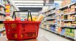 © Arman Design - Grocery shopping cart filled with food items on a supermarket aisle