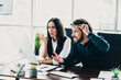 © deagreez - Business partners argue at the office desk over computer screen and documents