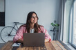 © Daniel - Dreamy young woman pondering ideas, sitting at desk with laptop, distracted from work, beautiful female looking in distance, taking break, dreaming or visualizing at home