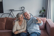 © Daniel - A cheerful older couple smiles at the camera while taking a selfie, showing affection and happiness as they create a lasting memory together using a phone in a relaxed setting