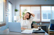 © Stella 16 - caucasian woman stretching arms while working from home, enjoying break time after long work on laptop computer