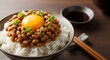 © Natsumae - Close-up of traditional Japanese natto fermented soybeans with raw egg yolk on rice
