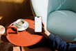 © Artem Podrez/Stocksy - Smartphone White Screen Mockup Near Cup on Red Table