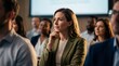 © RICKY - Thoughtful Woman Engaged in Business Conference Audience Listening Intently.