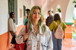 © J Esteban Berrío/Stocksy - Smiling student with green hair in school hallway