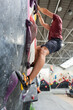 © Alvaro Lavin/Stocksy - Man bouldering on climbing wall in indoor gym