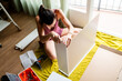 © Ibai Acevedo/Stocksy - Focused woman assembling new furniture