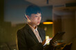 © Artcore Studio/Stocksy - Asian businesswoman working late with digital tablet in office